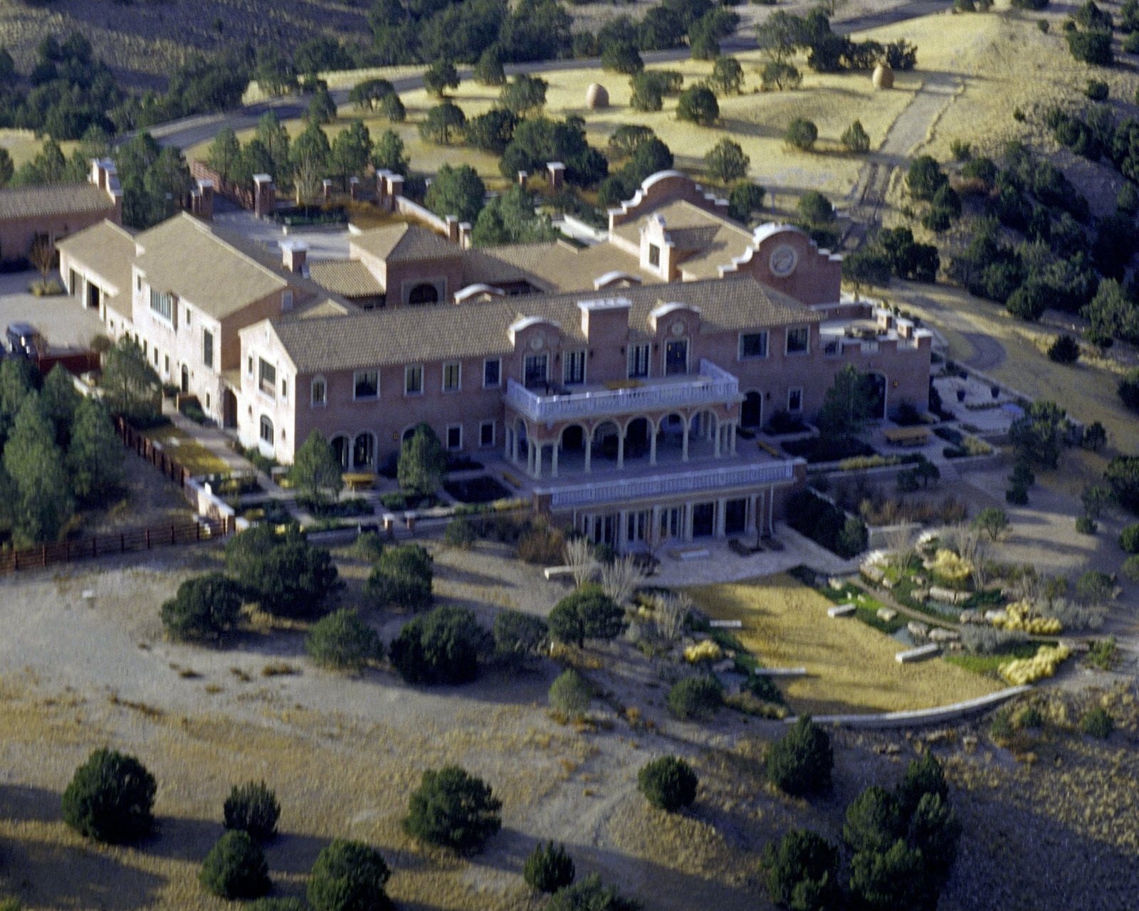 Aerial photo of the main house at Zorro Ranch, a large mansion on a desert hillside in New Mexico.